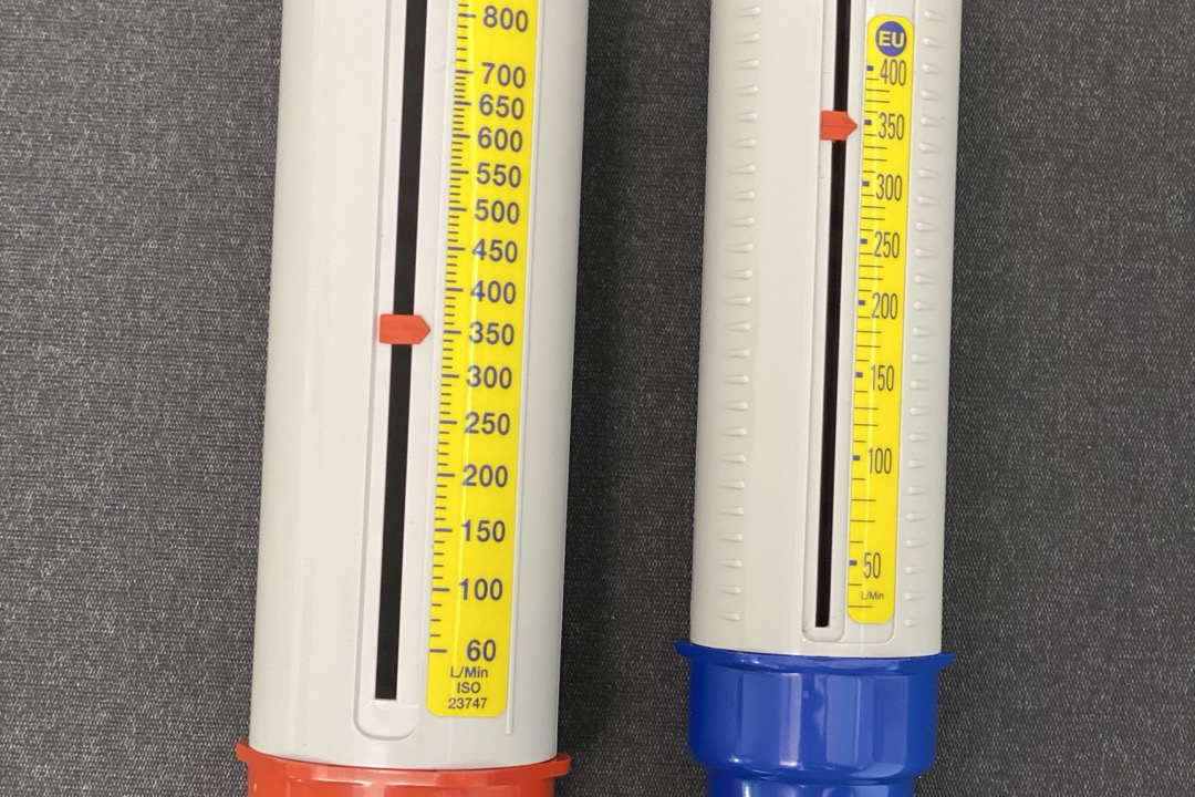 Patient using a peak flow meter to monitor asthma and lung function at home