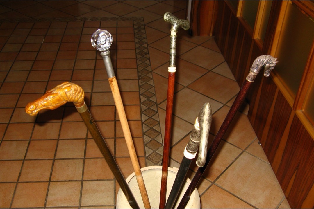 Walking cane with ergonomic offset handle on hardwood floor