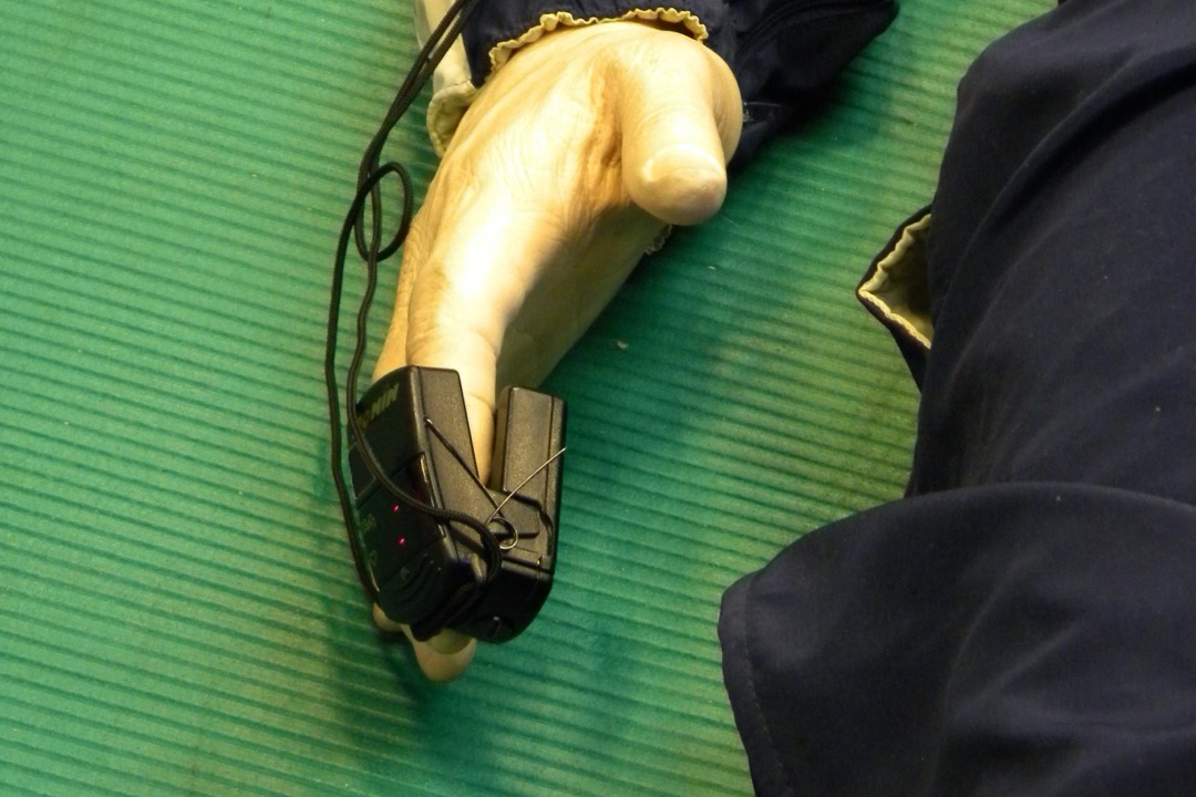 Fingertip pulse oximeter clipped on an index finger displaying an SpO2 oxygen saturation percentage and pulse rate