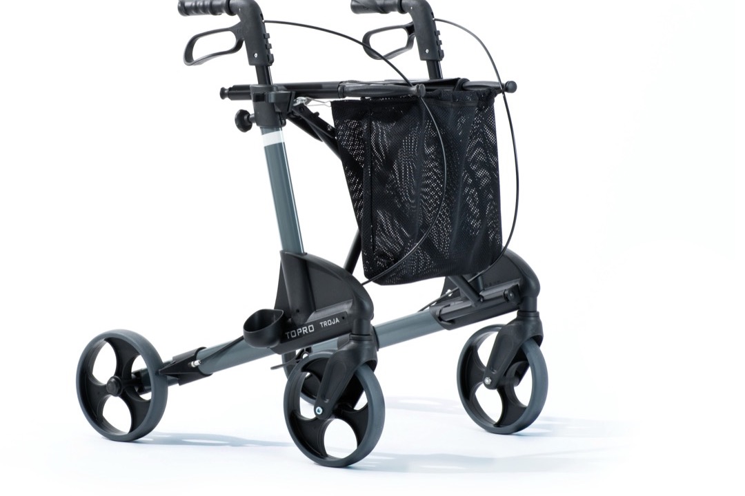 A four-wheeled rollator walker with hand brakes next to a standard aluminum walker on a white background
